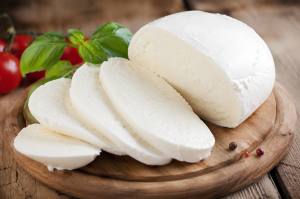Fresh mozzarella cheese on a wooden board